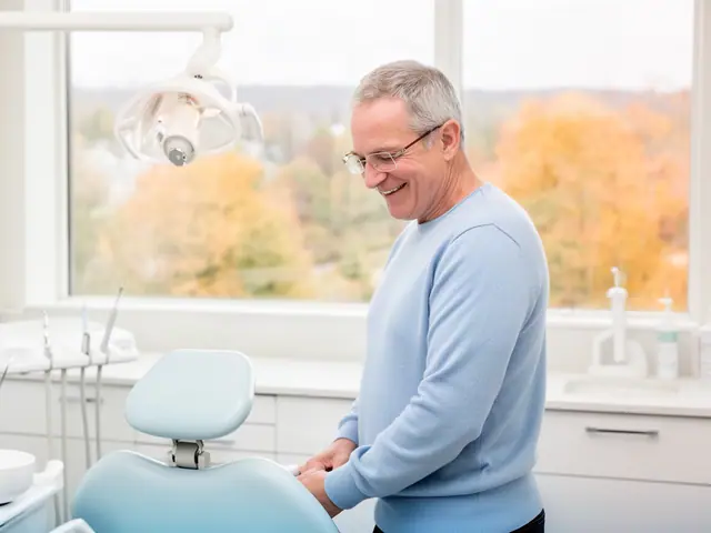 A dentist standing beside a dental chair.